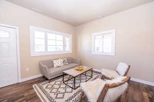 Living area with dark wood-style flooring