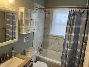 Bathroom featuring vanity and shower / bath combo