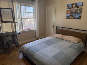 Bedroom with dark wood-type flooring