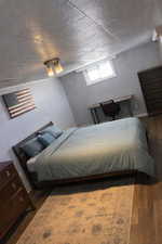 Bedroom with dark wood-style flooring