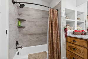 Full bathroom featuring shower / tub combo with curtain and vanity