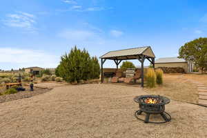 View of yard with a patio area and an outdoor fire pit