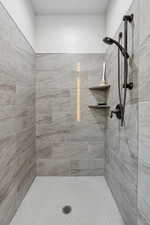 Full bath featuring tiled shower