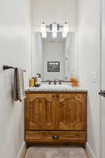 Bathroom with vanity and baseboards