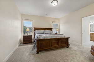 Bedroom with light carpet and baseboards