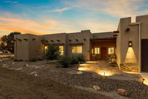 Back of house featuring a patio area and stucco siding