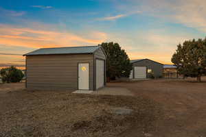 Garage at dusk with a detached garage