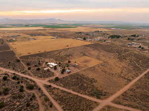 Aerial view at dusk of a rural view, a mountain view, and view of desert