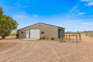 View of outdoor structure featuring driveway