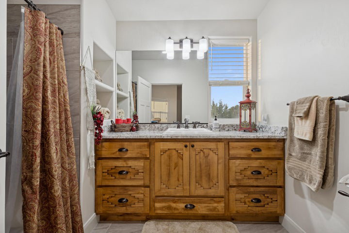 Full bath featuring vanity and a shower with shower curtain