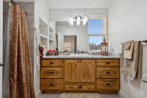 Full bath featuring vanity and a shower with shower curtain