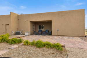Back of house with a patio and stucco siding