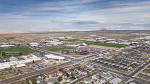 Aerial view of property and surrounding area with industrial structures