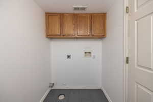 Laundry area with cabinet space, washer hookup, a textured ceiling, and electric dryer hookup
