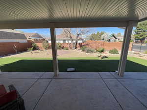 Fenced backyard featuring a patio and a residential view