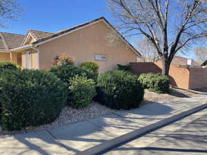 View of property exterior featuring stucco siding and a tile roof