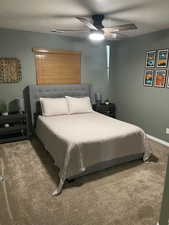 Carpeted bedroom featuring a ceiling fan