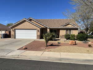Single story home featuring stucco siding, an attached garage, driveway, a tiled roof, and stone siding