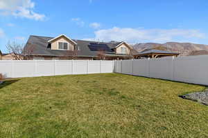 Fenced backyard with a mountain view