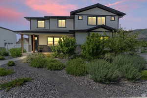 View of front of house with brick siding and covered porch