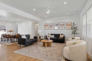 Living room with ceiling fan, wood finished floors, and recessed lighting