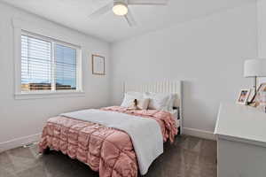 Bedroom featuring dark carpet and ceiling fan