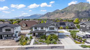 View of front of home featuring a mountain view, a residential view, and concrete driveway