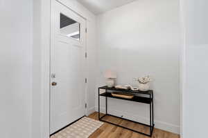 Foyer featuring light wood-type flooring and baseboards