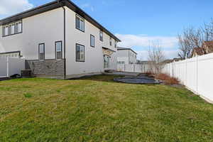 Rear view of house with a fenced backyard, a patio, a garage, and stucco siding