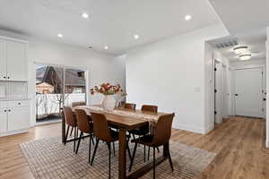 Dining space featuring light wood-type flooring and recessed lighting