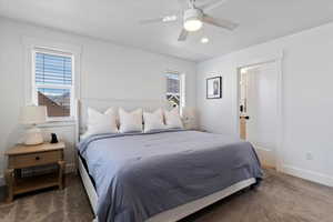 Bedroom featuring multiple windows, a ceiling fan, carpet flooring, and recessed lighting
