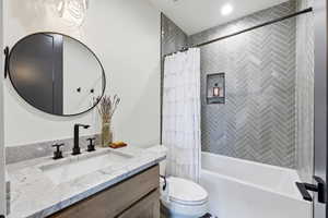 Full bath featuring vanity and shower / bathtub combination with curtain