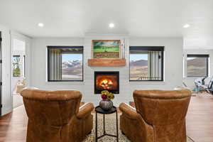 Living area featuring hardwood / wood-style floors, a fireplace, and recessed lighting