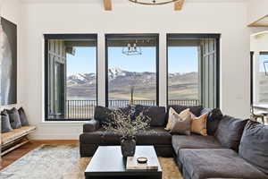 Living area featuring plenty of natural light, a chandelier, and wood finished floors