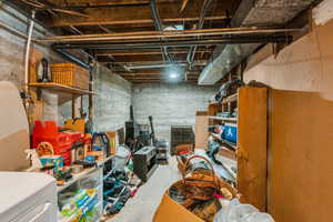 Unfinished basement featuring washer / clothes dryer