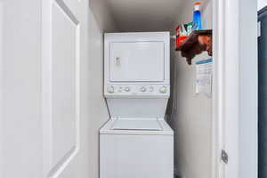 Laundry area featuring stacked washer and dryer