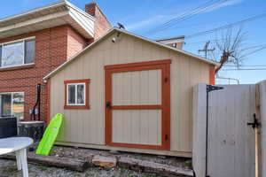 View of shed featuring a gate
