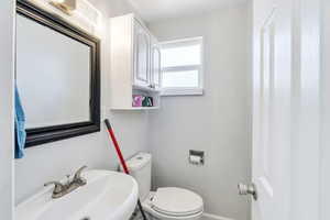 Half bathroom with toilet and a sink