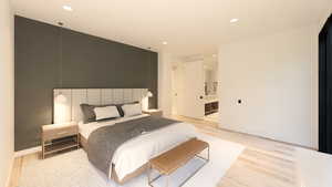 Bedroom featuring recessed lighting, light wood-style floors, and ensuite bathroom