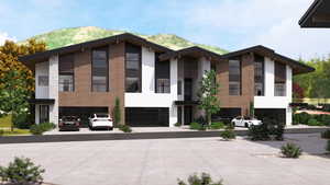 View of front of home with an attached garage and stucco siding