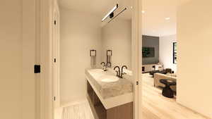 Full bath featuring double vanity, recessed lighting, and light wood-type flooring