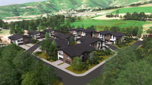 Drone / aerial view of a mountainous background and a golf course