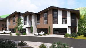 View of front facade featuring stucco siding and an attached garage