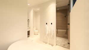 Full bath with a stall shower, vanity, and recessed lighting