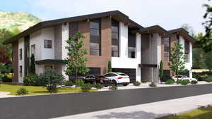 View of front of house featuring an attached garage, stucco siding, and driveway
