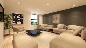 Living room with recessed lighting, wood finished floors, and an accent wall