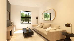 Living area with plenty of natural light, recessed lighting, and light wood-style floors