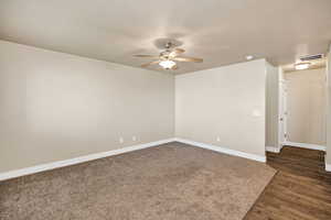 Spare room featuring ceiling fan and dark wood finished floors