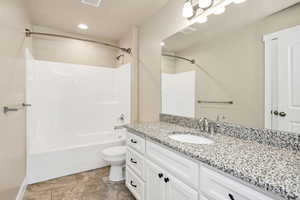 Bathroom with vanity and tub / shower combination