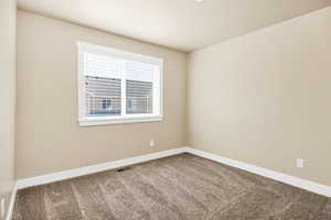 Unfurnished room with carpet floors and baseboards
